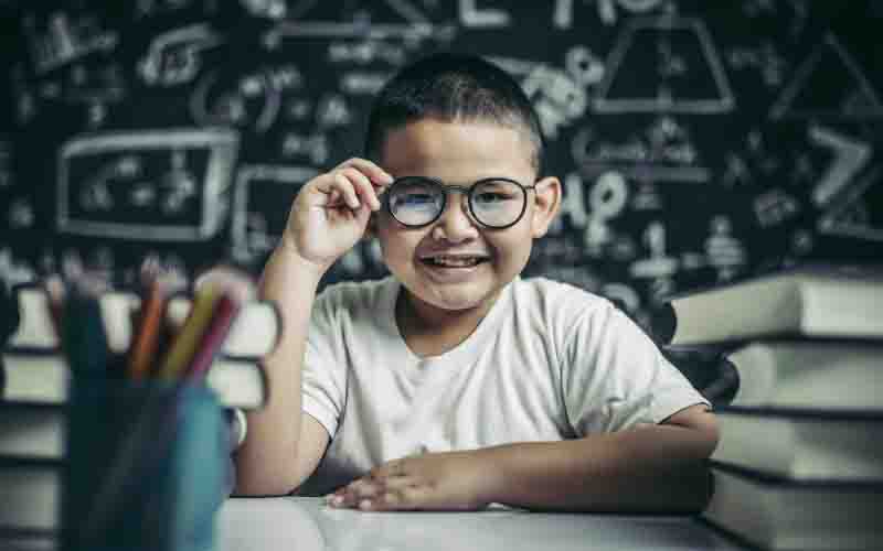 boy-studying-holding-glasses-leg-classroom-1.jpg